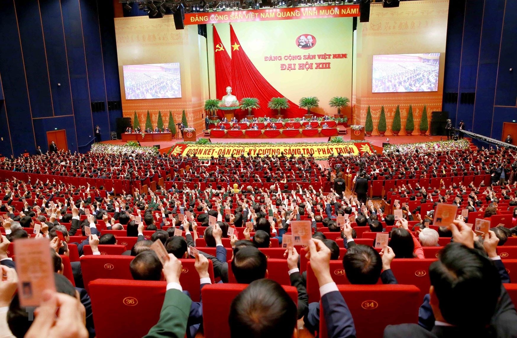 Các đại biểu thông qua Nghị quyết Đại hội XIII. (Nguồn: TTXVN)